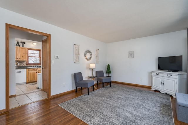 sitting room with wood finished floors and baseboards