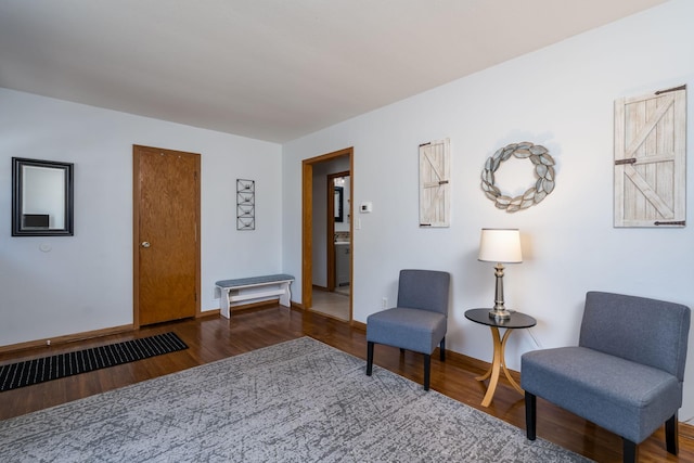 living area featuring baseboards and wood finished floors