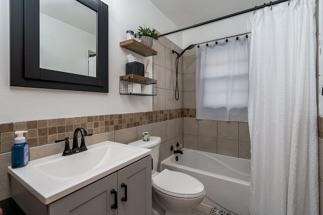 full bath with tile walls, vanity, toilet, and shower / tub combo with curtain