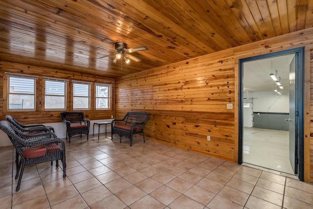 sitting room featuring light tile patterned floors, wooden ceiling, and ceiling fan