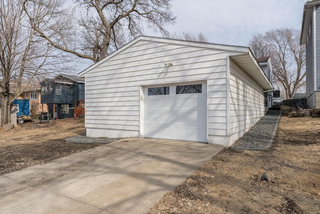 detached garage featuring concrete driveway