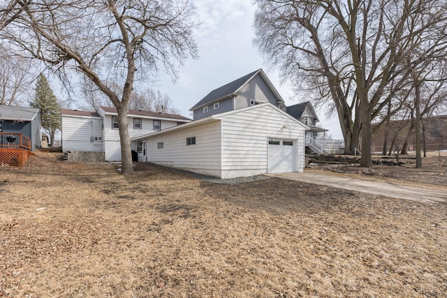 back of house with an attached garage and driveway