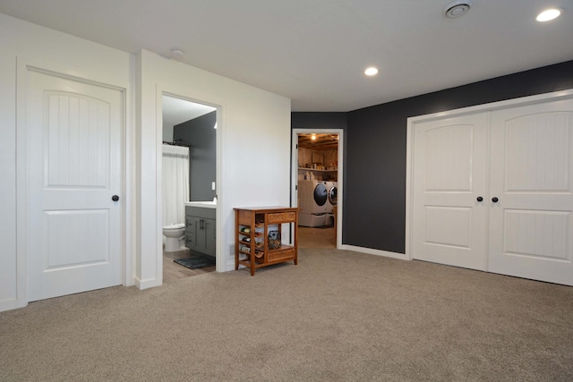 carpeted bedroom featuring washing machine and clothes dryer, baseboards, recessed lighting, a closet, and ensuite bath