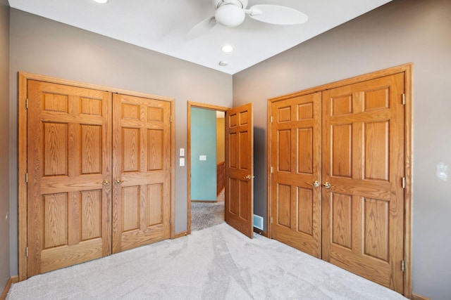 carpeted bedroom featuring a closet, baseboards, and ceiling fan