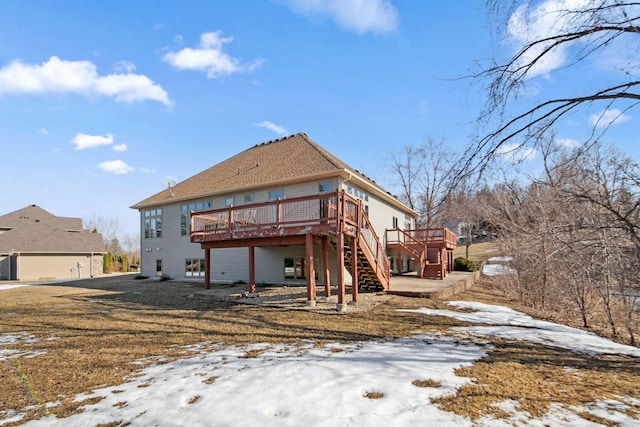 snow covered property featuring stairs and a deck