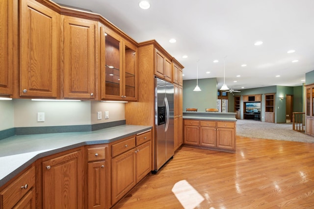 kitchen featuring recessed lighting, stainless steel fridge, brown cabinets, and ceiling fan