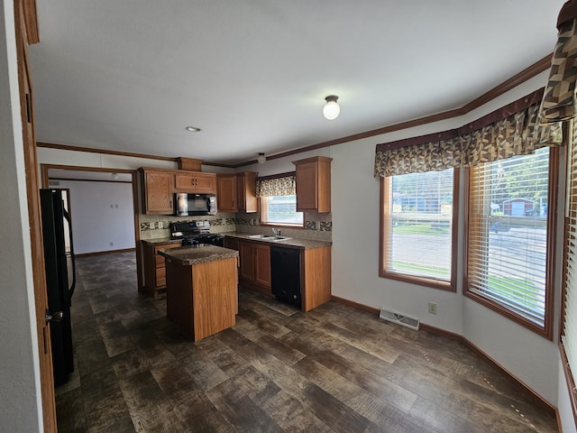 kitchen featuring black appliances, visible vents, dark wood-style flooring, and ornamental molding