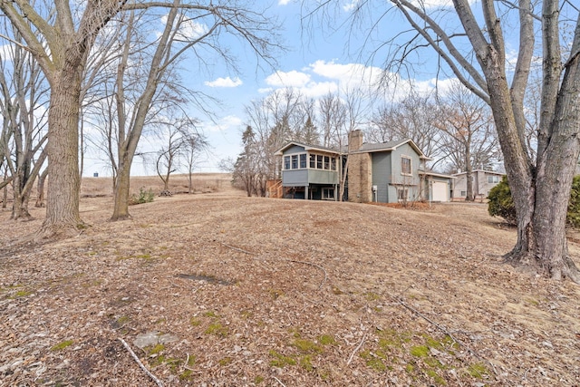 rear view of house with a deck and a chimney