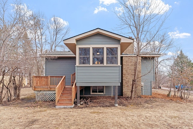 back of property featuring a wooden deck