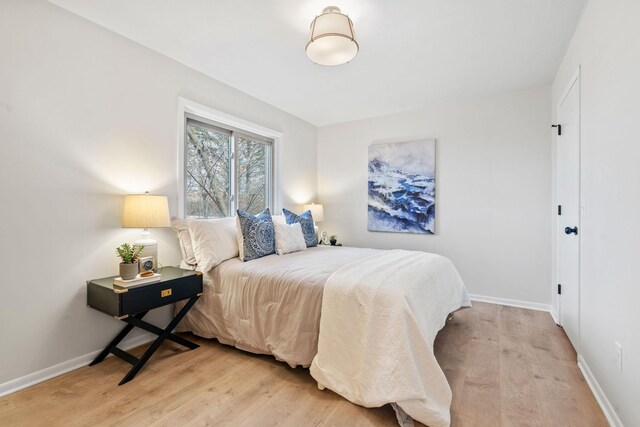 bedroom with baseboards and light wood-style floors