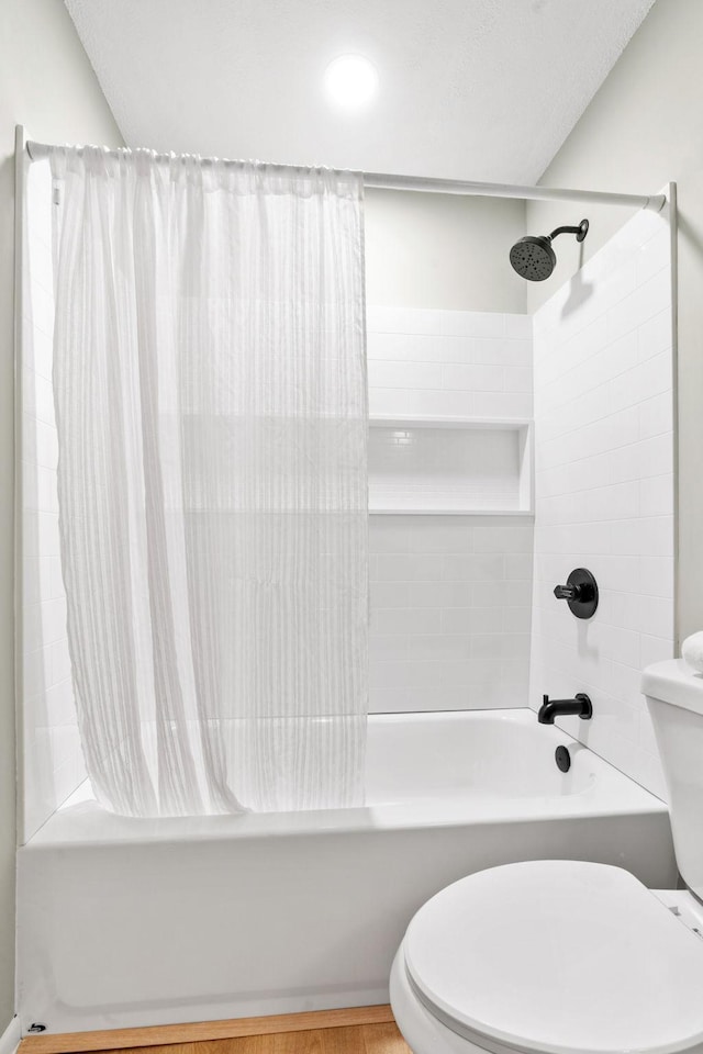 full bathroom featuring shower / tub combo and toilet