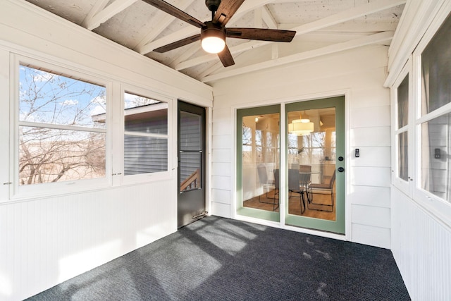 unfurnished sunroom with ceiling fan and vaulted ceiling with beams