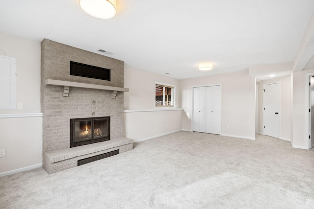 unfurnished living room featuring visible vents, carpet floors, baseboards, and a fireplace