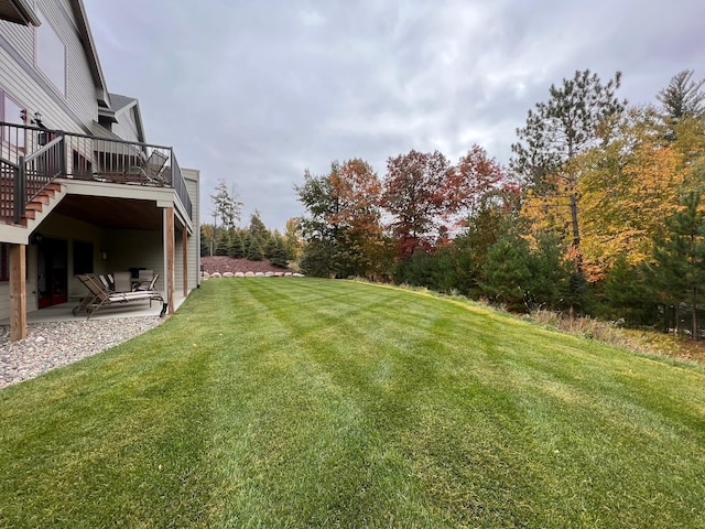 view of yard with a patio area and a wooden deck