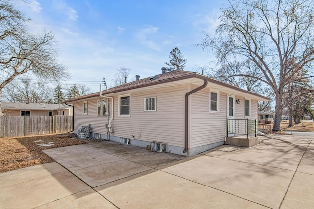 rear view of house with a patio area and fence