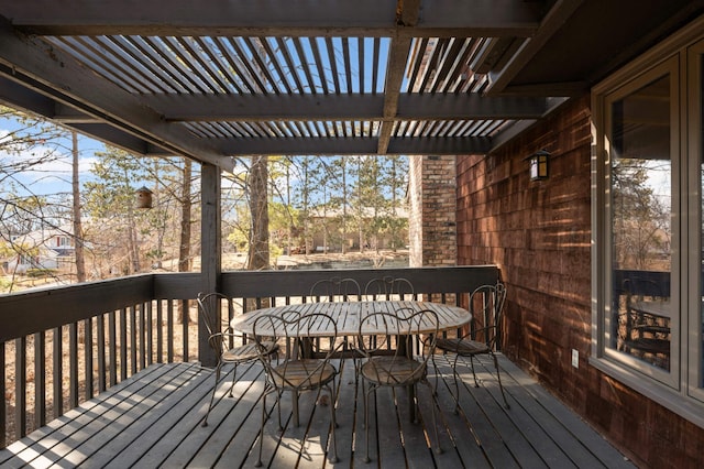 deck featuring a pergola and outdoor dining area