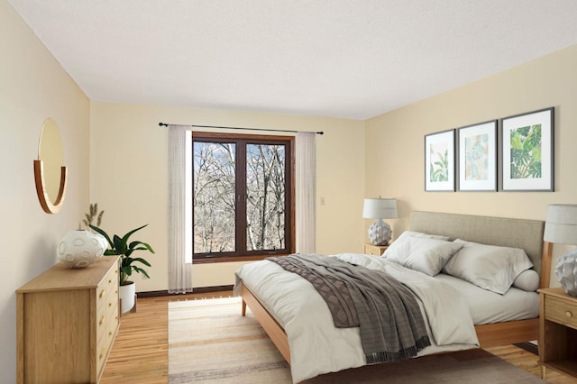 bedroom featuring baseboards and light wood-type flooring