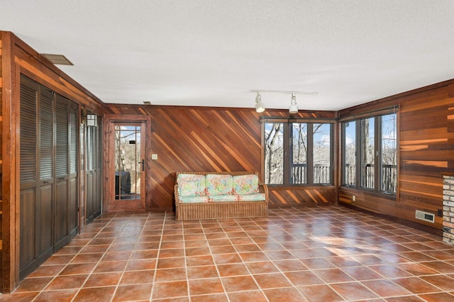 unfurnished sunroom featuring visible vents