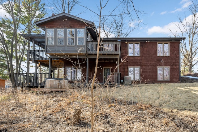 rear view of house with central air condition unit and a wooden deck