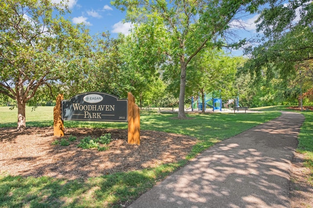 view of home's community with playground community and a lawn