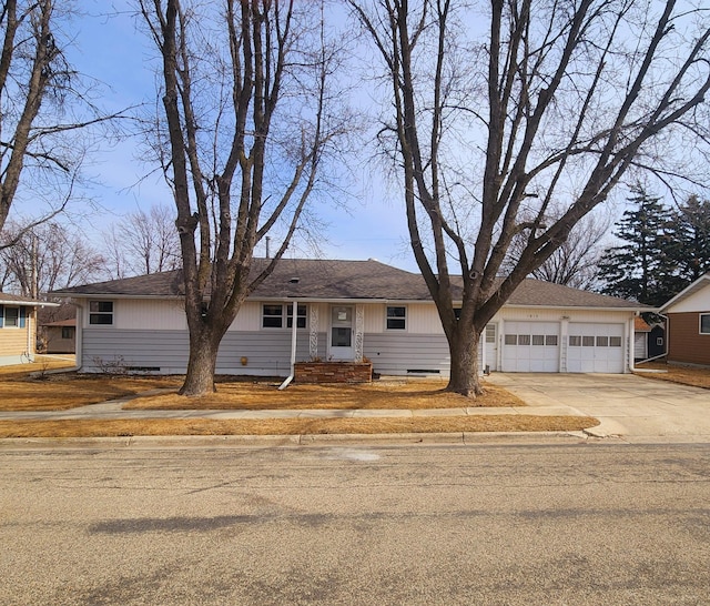 ranch-style house featuring a shingled roof, concrete driveway, an attached garage, and crawl space