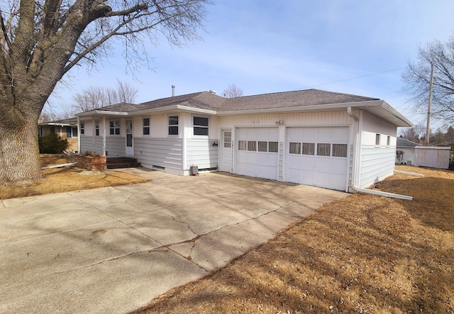 view of front of property with crawl space, an attached garage, driveway, and a shingled roof