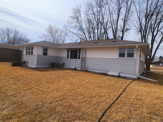 rear view of property with a lawn