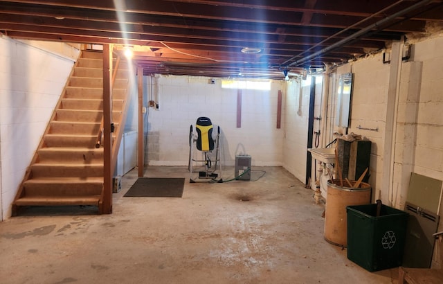 unfinished basement featuring stairs