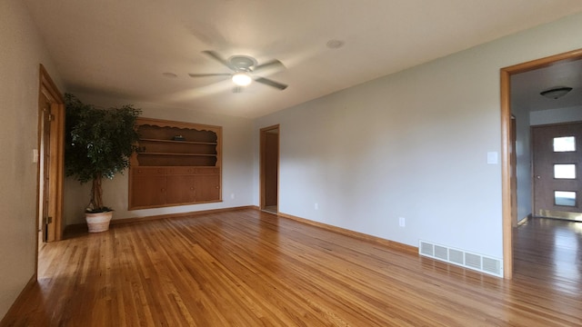 1013 8th Ave SW, Pipestone, MN 56164 - empty room featuring wood finished floors, ceiling fan, and baseboards