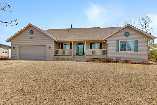 ranch-style home with driveway, an attached garage, covered porch, and roof with shingles