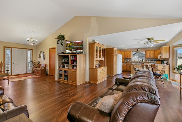 living room featuring dark wood finished floors, ceiling fan with notable chandelier, and high vaulted ceiling