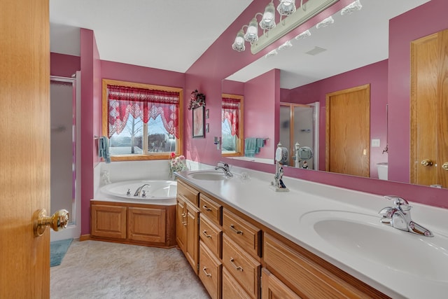 full bathroom with a garden tub, a stall shower, and a sink