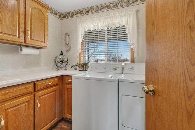 washroom with cabinet space and washing machine and dryer