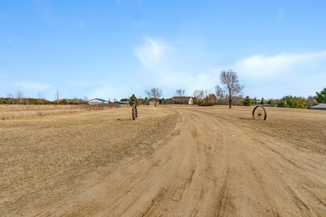 view of street featuring a rural view and dirt driveway