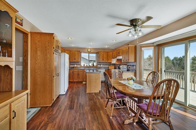 dining room with a textured ceiling, ceiling fan, dark wood finished floors, and recessed lighting