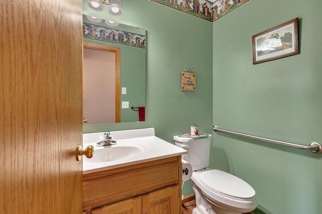 bathroom with toilet and vanity