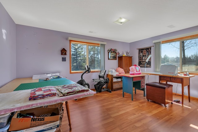 bedroom featuring wood finished floors and visible vents