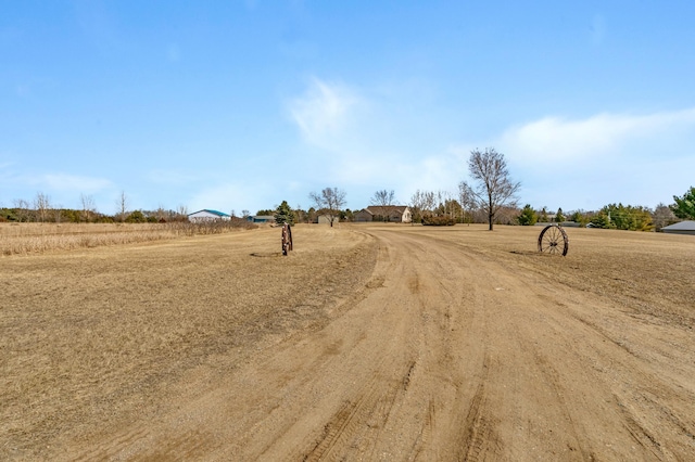 view of road featuring driveway and a rural view
