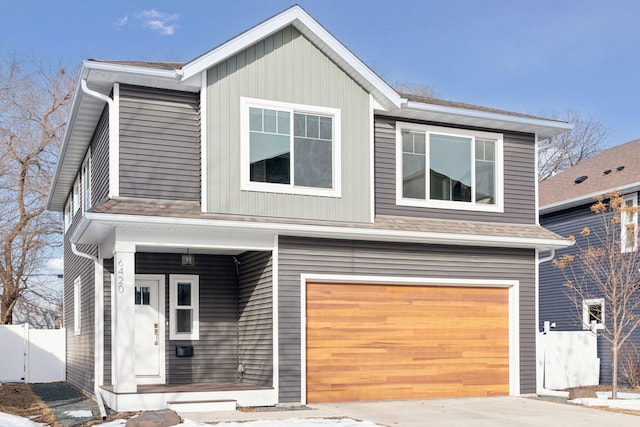 view of front facade featuring an attached garage and fence