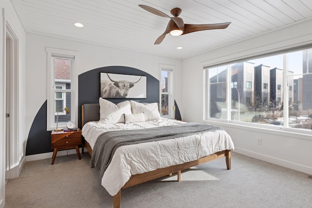 bedroom featuring baseboards, wood ceiling, and carpet flooring