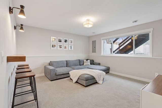 living area with electric panel, baseboards, and carpet flooring