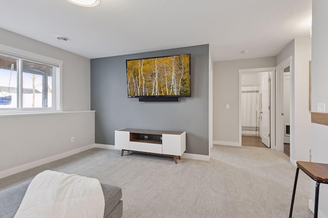 living area with baseboards and carpet floors