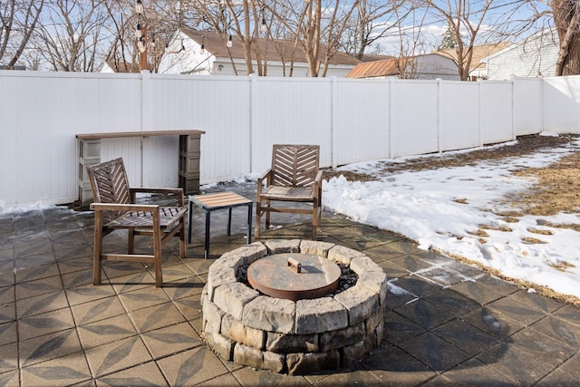 view of patio / terrace featuring a fire pit and fence