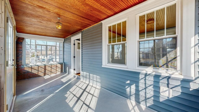 unfurnished sunroom featuring wooden ceiling