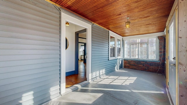 unfurnished sunroom featuring wooden ceiling