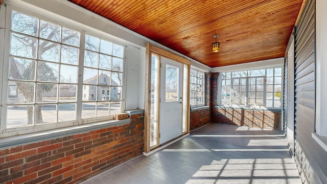 unfurnished sunroom with wood ceiling