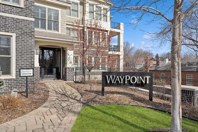 community / neighborhood sign featuring fence