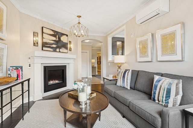 living room with arched walkways, wood finished floors, crown molding, and a wall unit AC