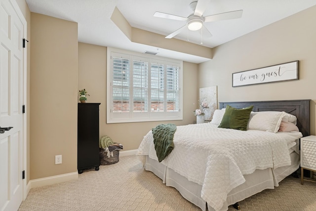 carpeted bedroom with visible vents, ceiling fan, and baseboards