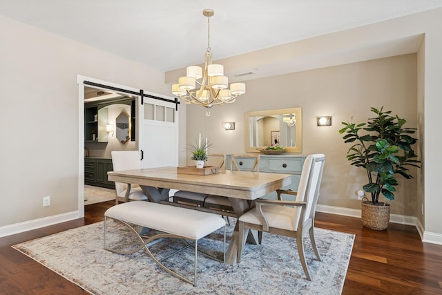 dining area featuring visible vents, dark wood-type flooring, baseboards, a barn door, and an inviting chandelier